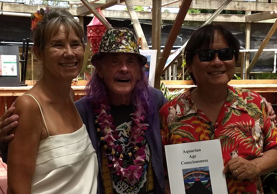 Wide poses with his friends and his book the Aquarian Age Consciousness
